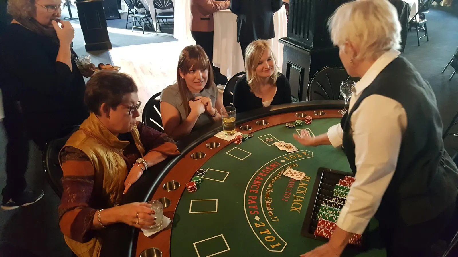Guests enjoying blackjack with a dealer