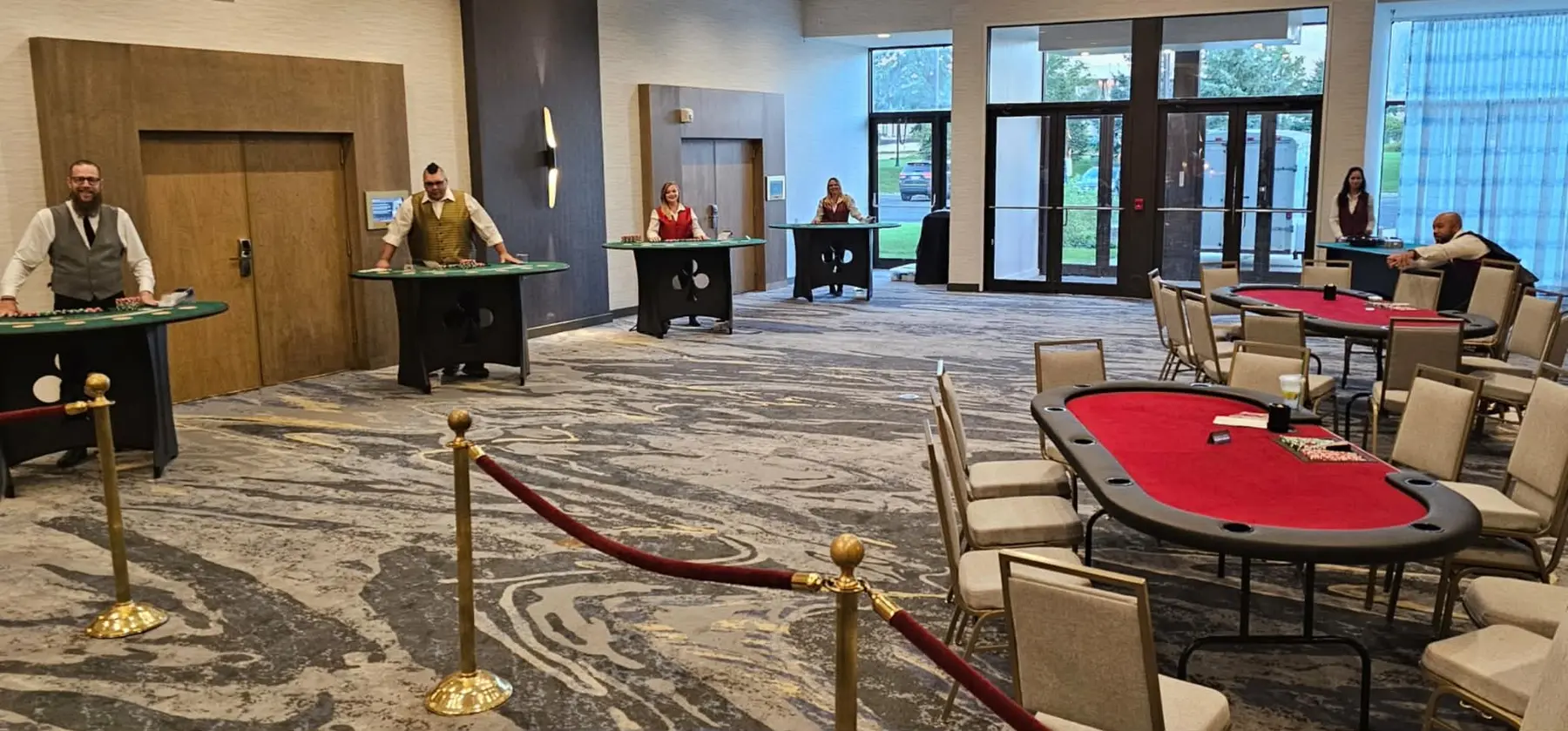 Multiple casino tables and professional dealers arranged for a large event